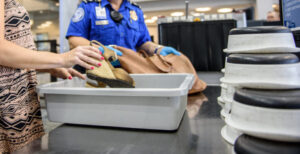 TSA officer is helping a woman at the TSA Checkpoint at Huntsville International Airport